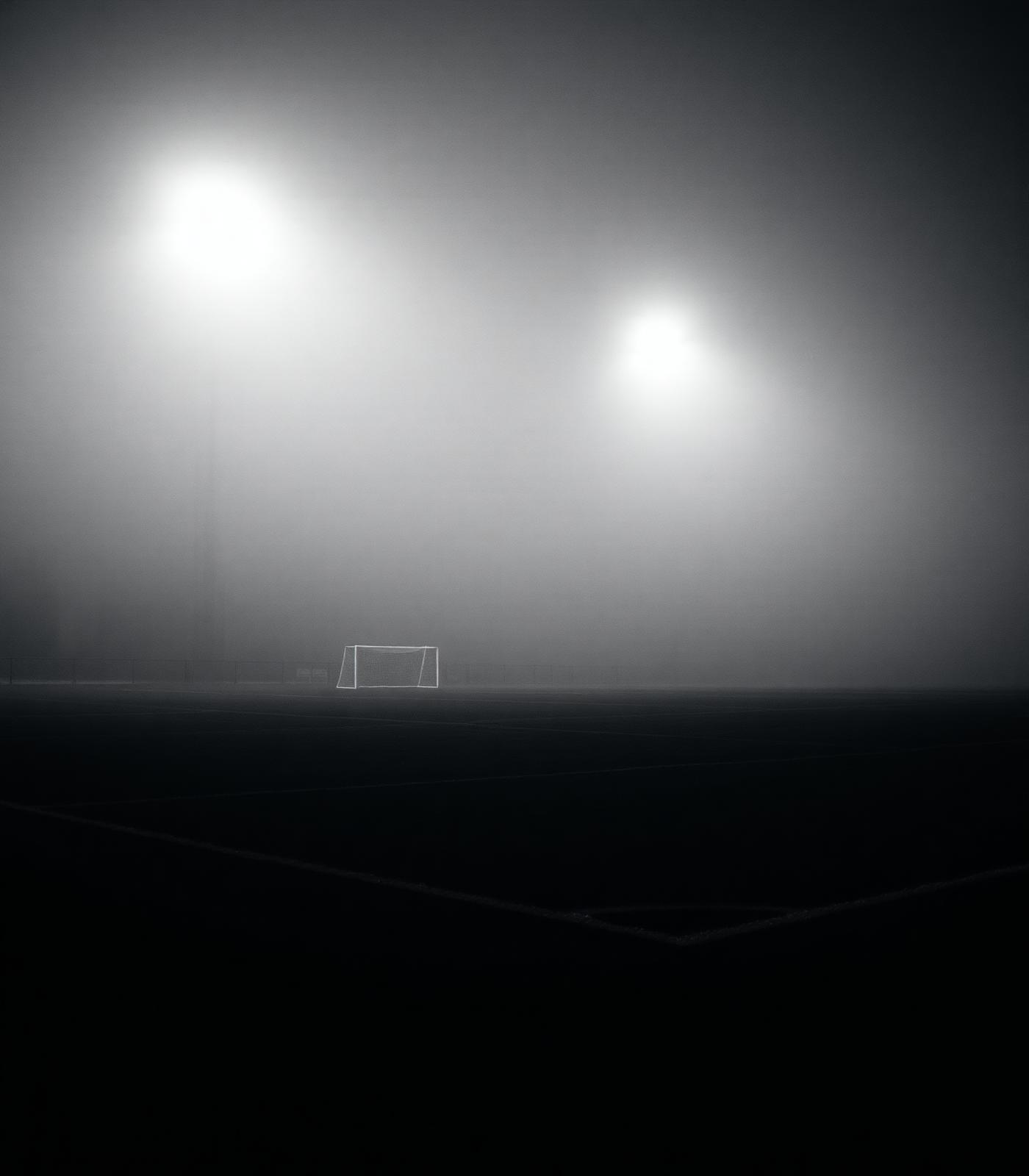Empty grass pitch under floodlights